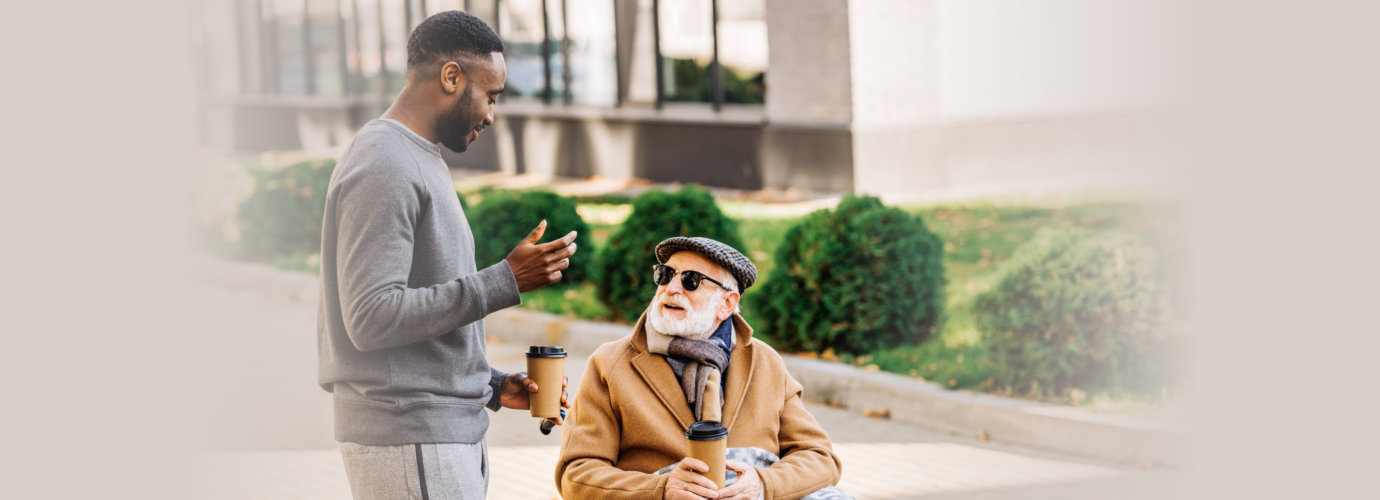 senior man and caregiver drinking coffee