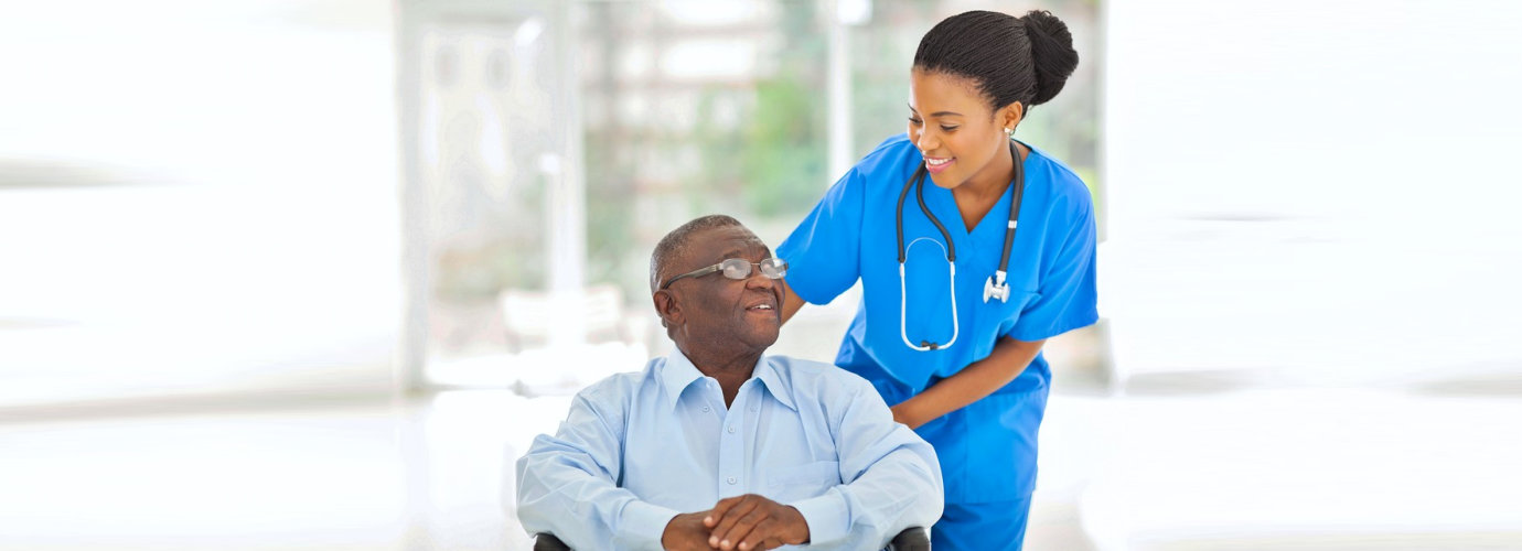 african nurse taking care of senior patient in wheelchair